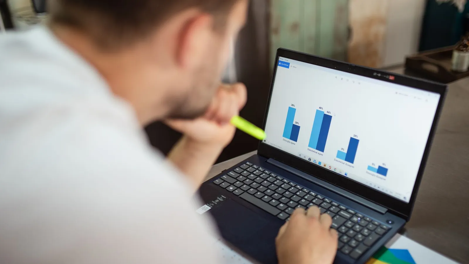 Analyst reviewing bar charts on a laptop to understand AI Mode impressions, clicks and position