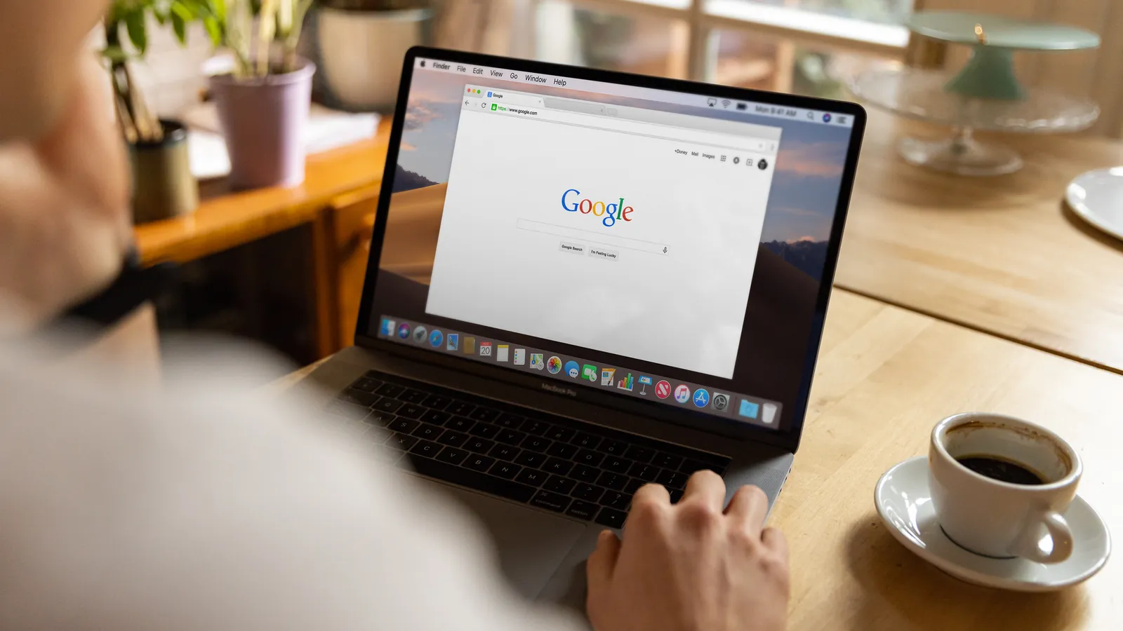 Person using Google Search on a laptop, where AI Overviews take a single position