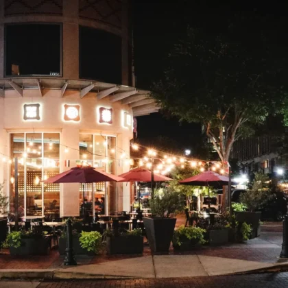 Sugar Land, Texas town square at night with outdoor dining, home to the SEO agencies reviewed in this guide