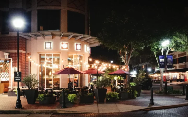 Sugar Land, Texas town square at night with outdoor dining, home to the SEO agencies reviewed in this guide