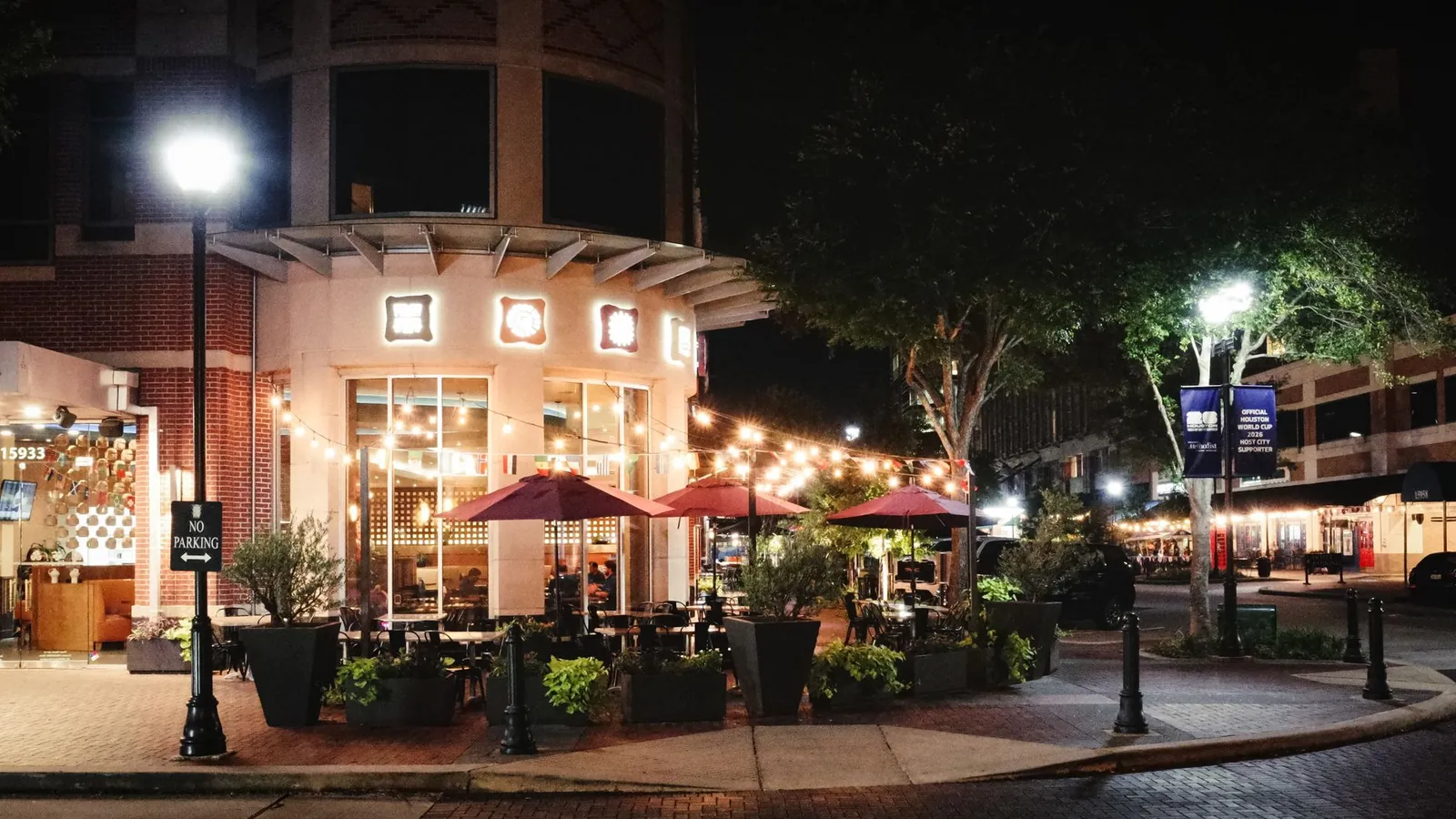 Sugar Land, Texas town square at night with outdoor dining, home to the SEO agencies reviewed in this guide