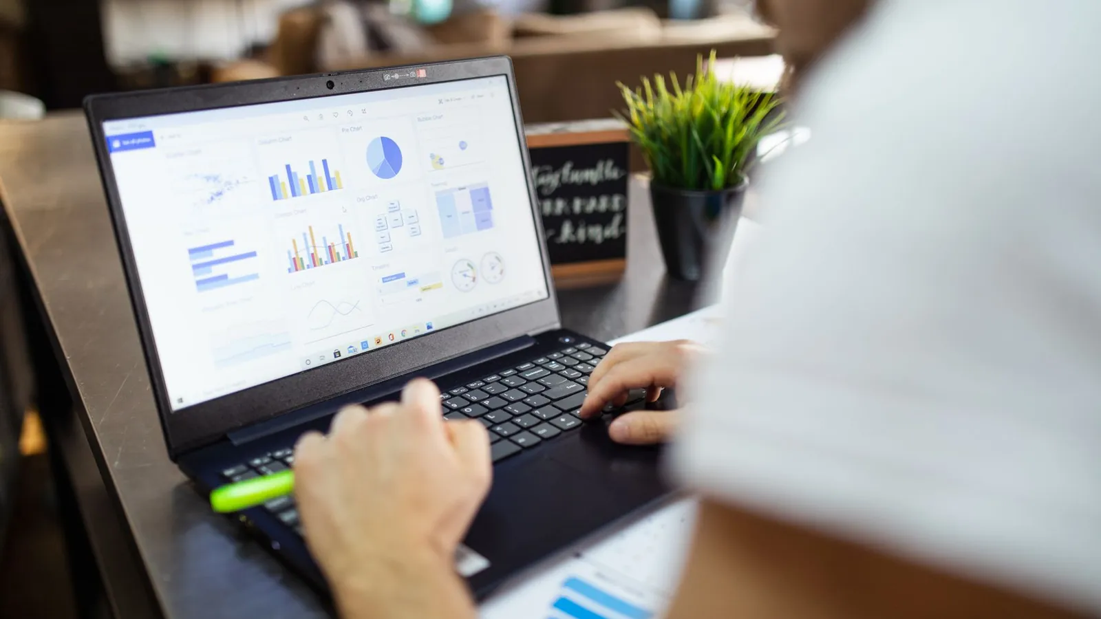 Person working with a data dashboard on a laptop after exporting generative AI performance data
