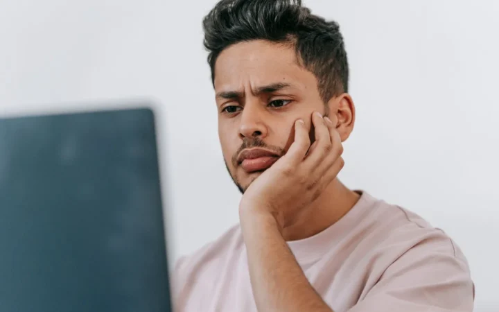 Site owner looking puzzled at a laptop when the generative AI report is not showing in Search Console