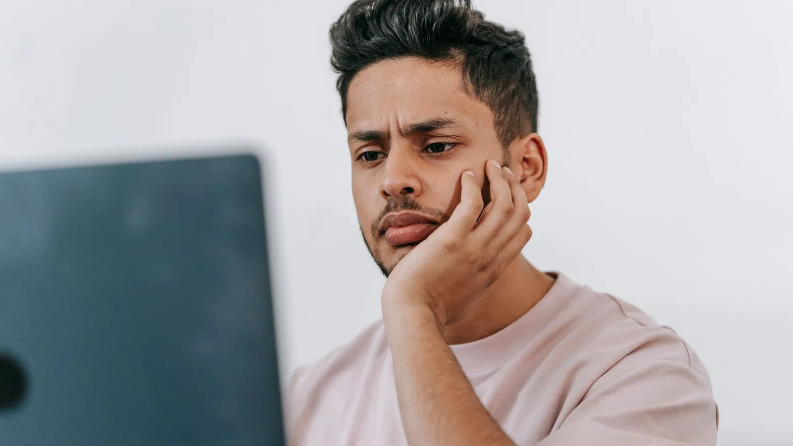 Site owner looking puzzled at a laptop when the generative AI report is not showing in Search Console
