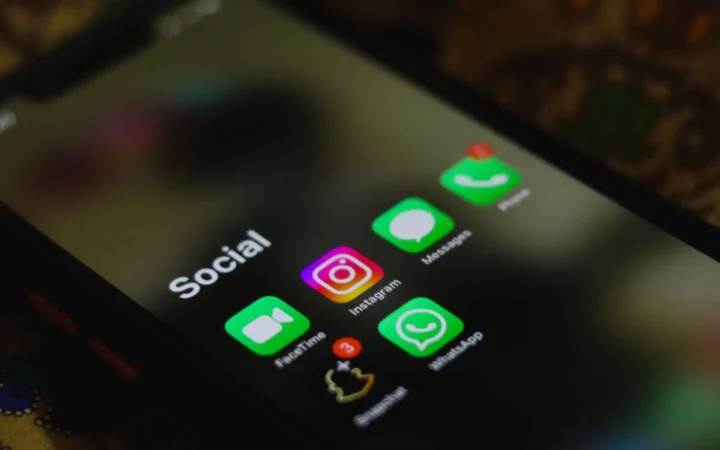 Smartphone showing the Instagram app in a social apps folder, the account auto follower tools target