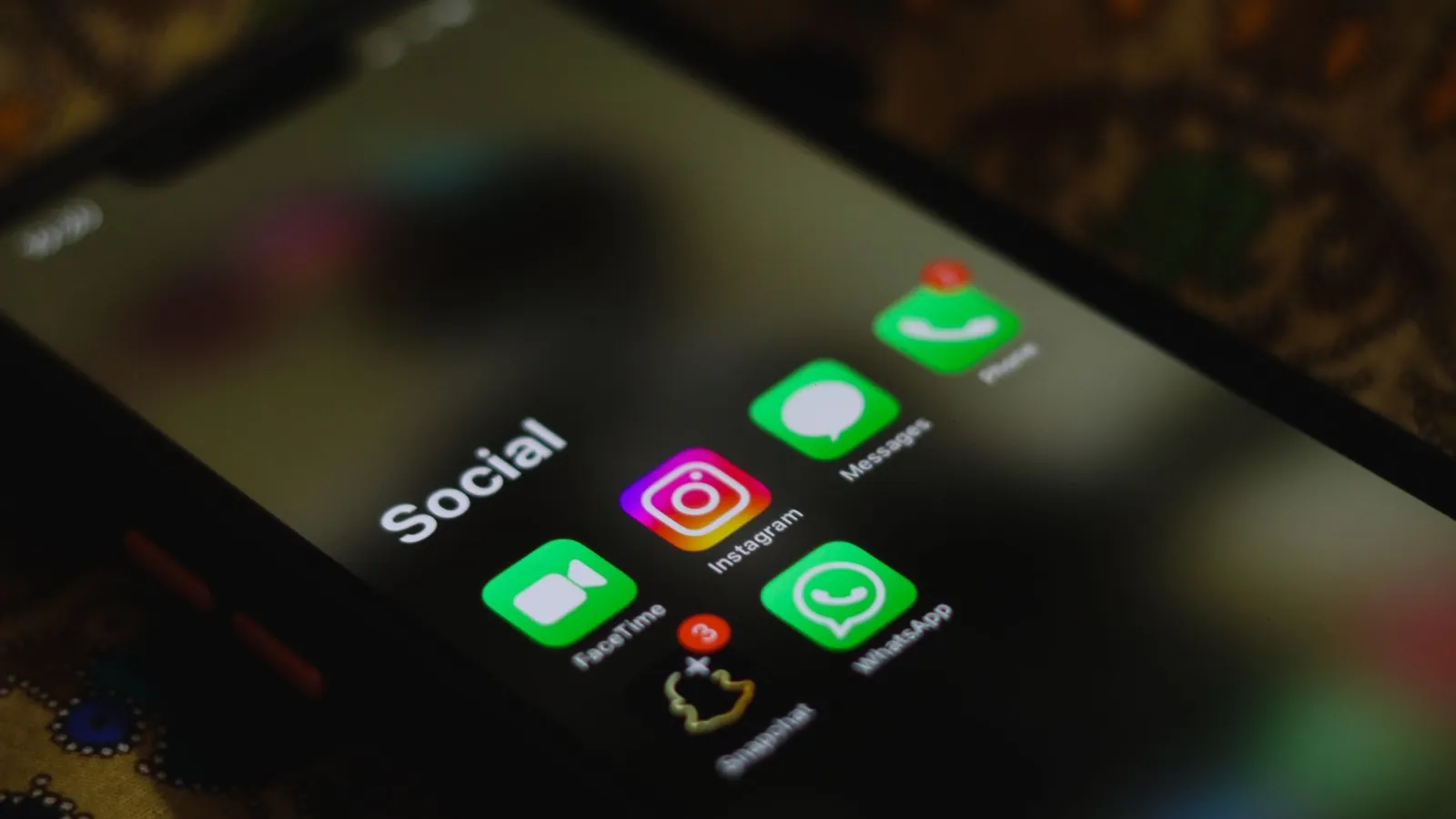 Smartphone showing the Instagram app in a social apps folder, the account auto follower tools target