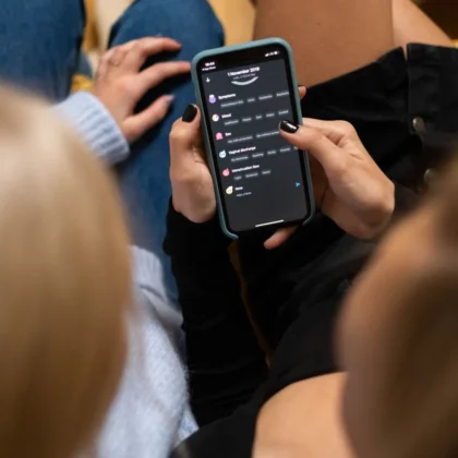 Person browsing a social media app on a phone, comparing app analytics with Google Search Console data