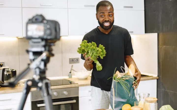 YouTube creator filming a cooking video on a tripod camera, comparing Shorts and long videos in Search Console